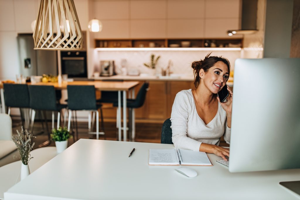 Woman on Phone, at Computer