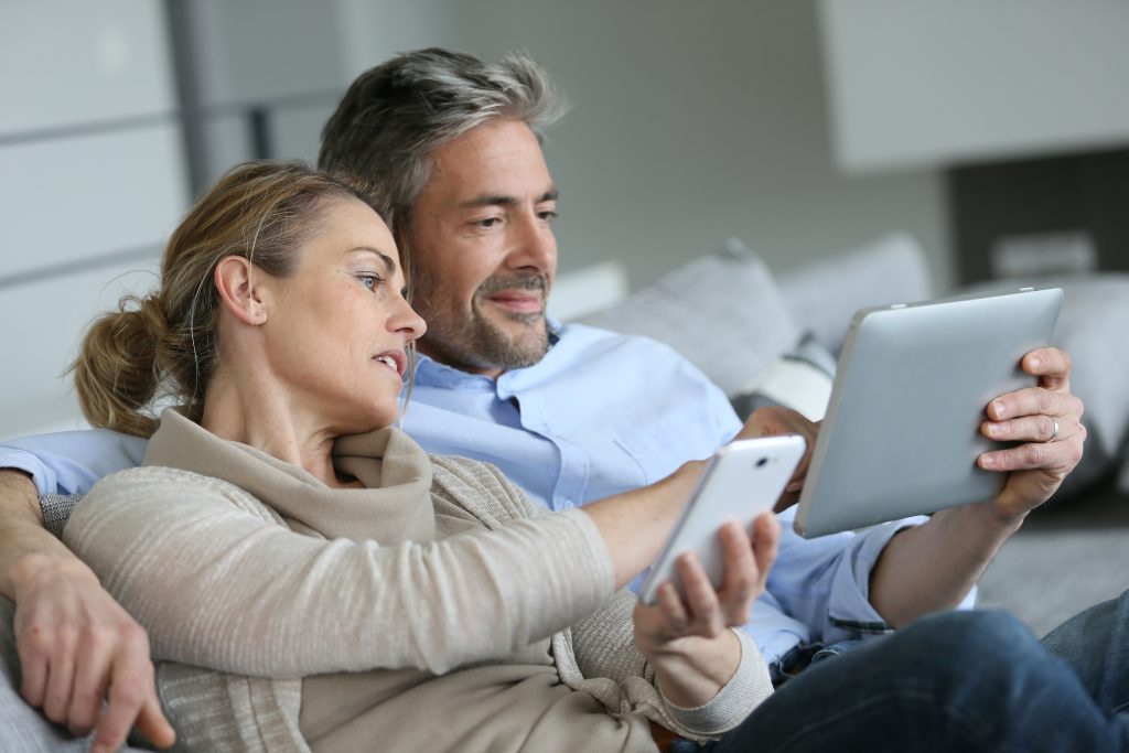 Mature Couple on Tablet and Phone