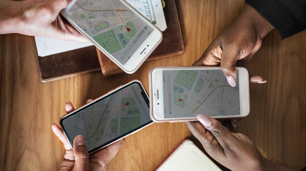 group of women holding their phones and looking for local internet service providers