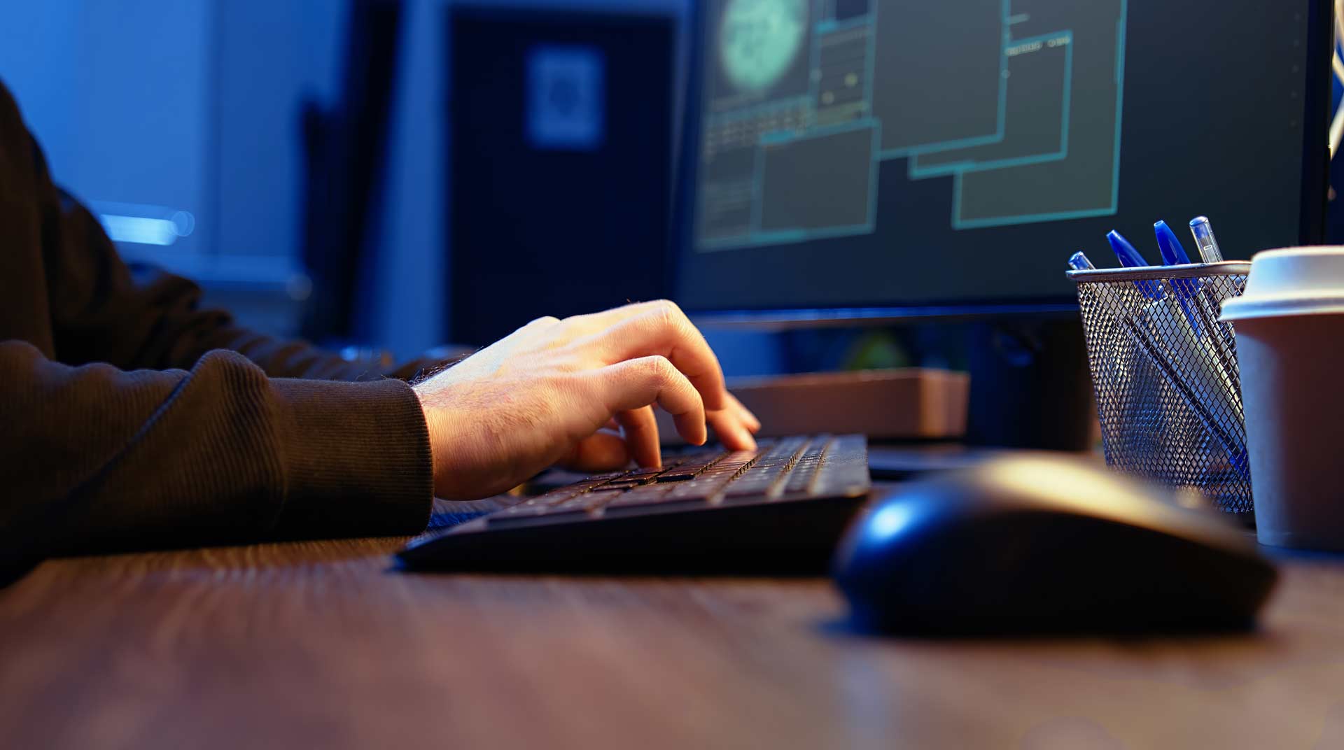 close up of a person's hands typing on a desktop computer's keyboard