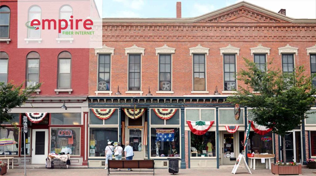 three woman looking into a downtown Mt Morris storefront
