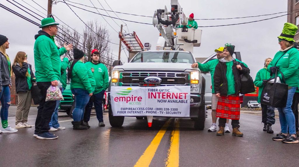 scene of Empire Access employees with an Empire Access truck getting ready for a parade