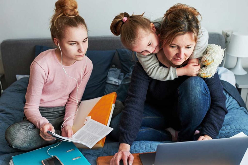 Mom with two children looking at laptop together