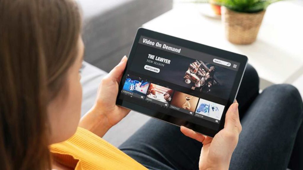 Woman looking at a tablet using her fiber internet