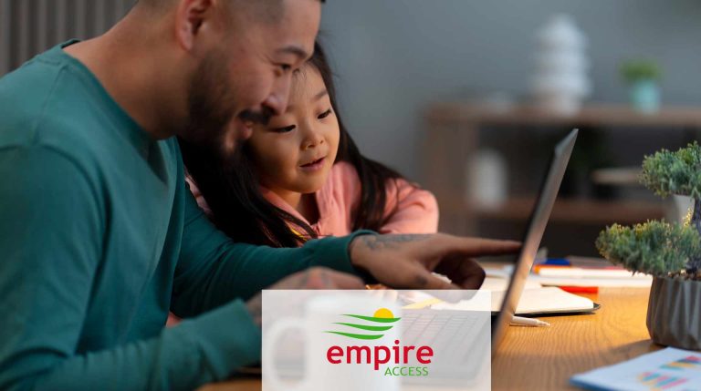 Father and daughter looking at a laptop