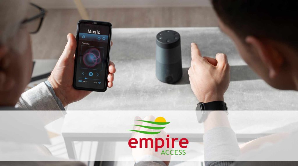 Man showing elderly man how to connect his smart home device to his phone