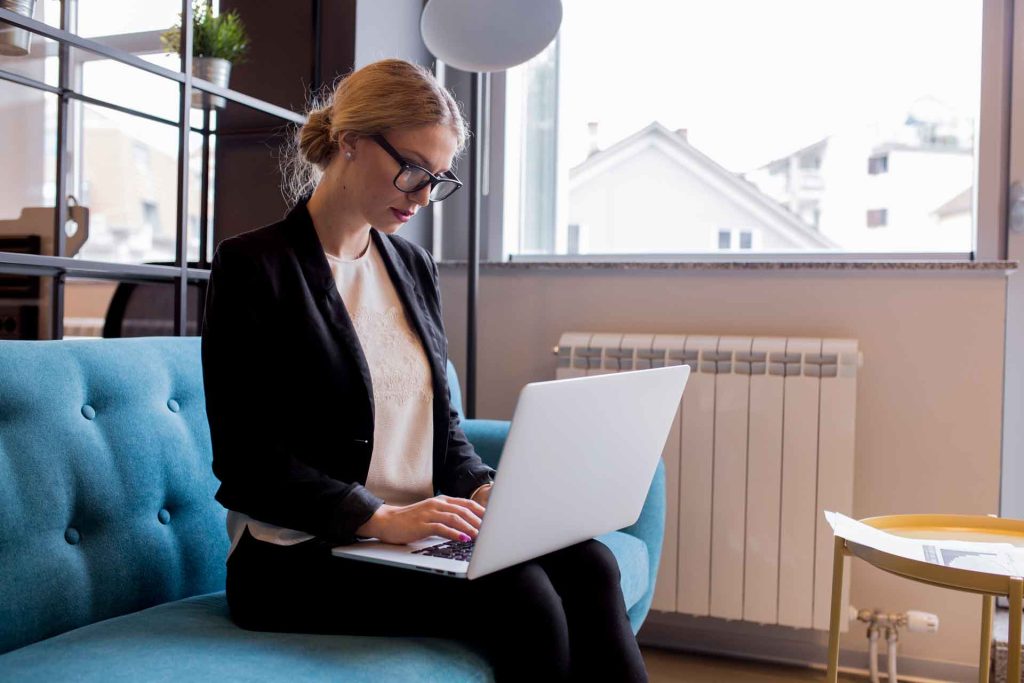 Businesswoman using her laptop to work from home